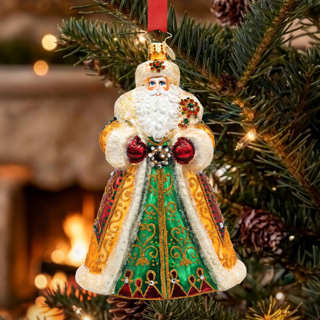 The 2026 Christopher Radko Designer's Choice ornament, Crown of Christmas, shines with rich emerald and burgundy hues, shimmering gold accents, and exquisite hand-crafted detail.