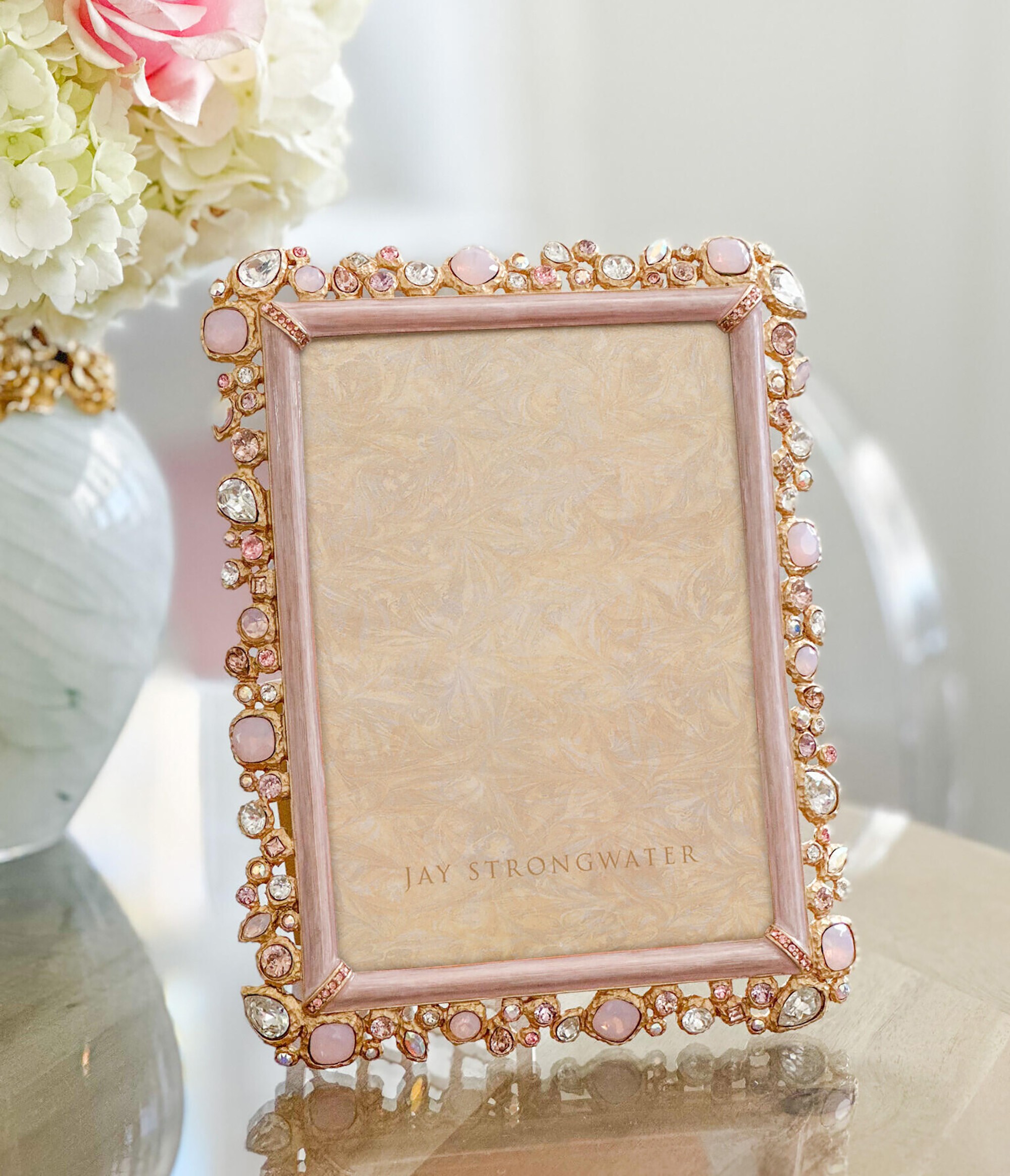 Crafted of pewter with a 14K matte gold finish, the Leslie Bejeweled 5" x 7" Frame is a treasure for any household. Hand-enameled and hand-set with large crystal stones.