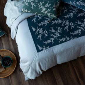 An overhead shot of the Bella Notte Linens Lynette Luxe Duvet Cover showcasing the inset of Lynette embroidered silk velvet framed by Tencel™ used in our Madera Luxe collection. 