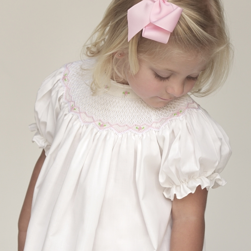 Pink bishop dress with English smocking. Puff sleeves, buttons in back.