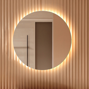 Luna unfrosted round mirror with wall glow emanating from behind with polished edge, specifically designed for bathroom application