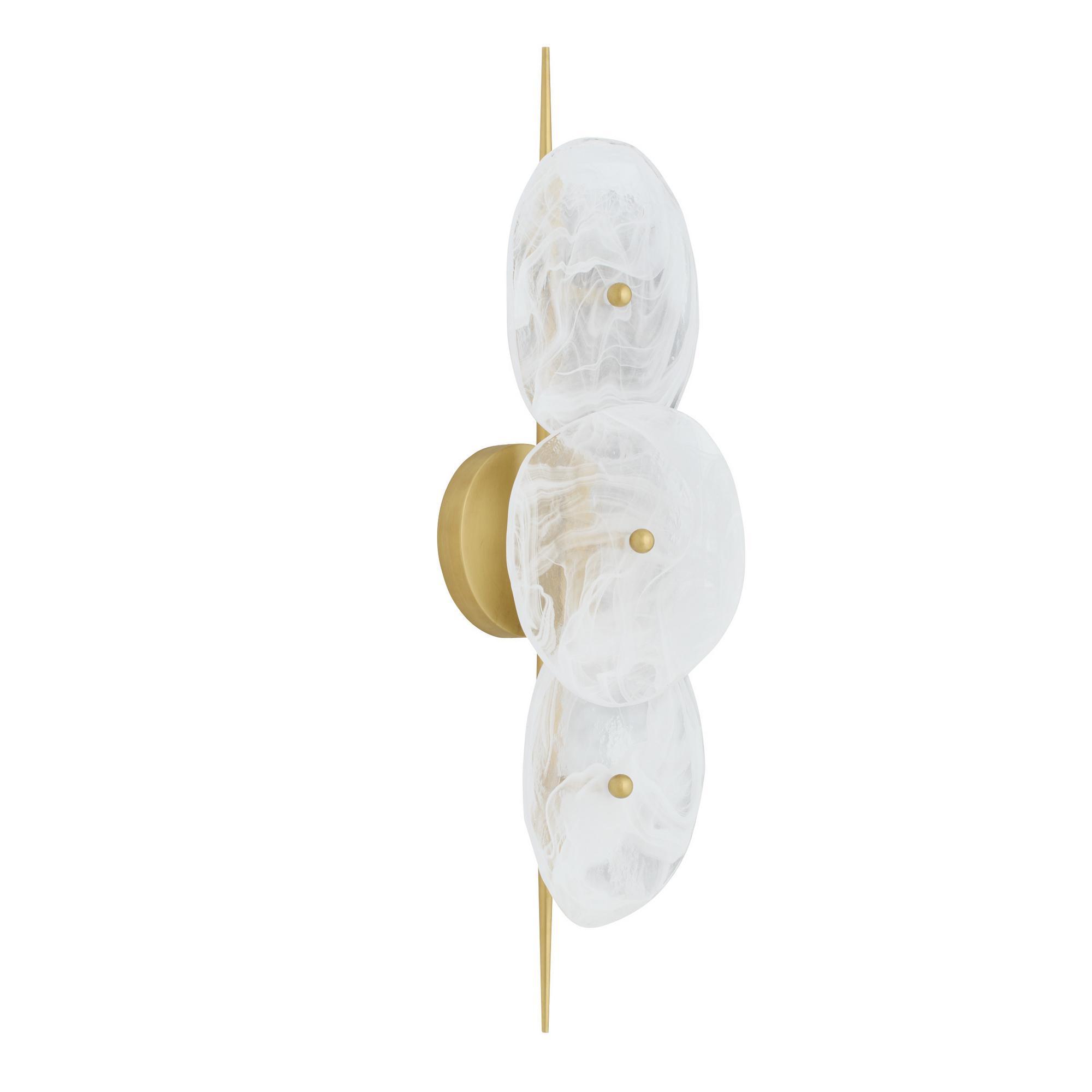  Offering a mix of transparency and opacity, each free-form shape is secured with a steel antique brass finial detail and will differ slightly from fixture to fixture.