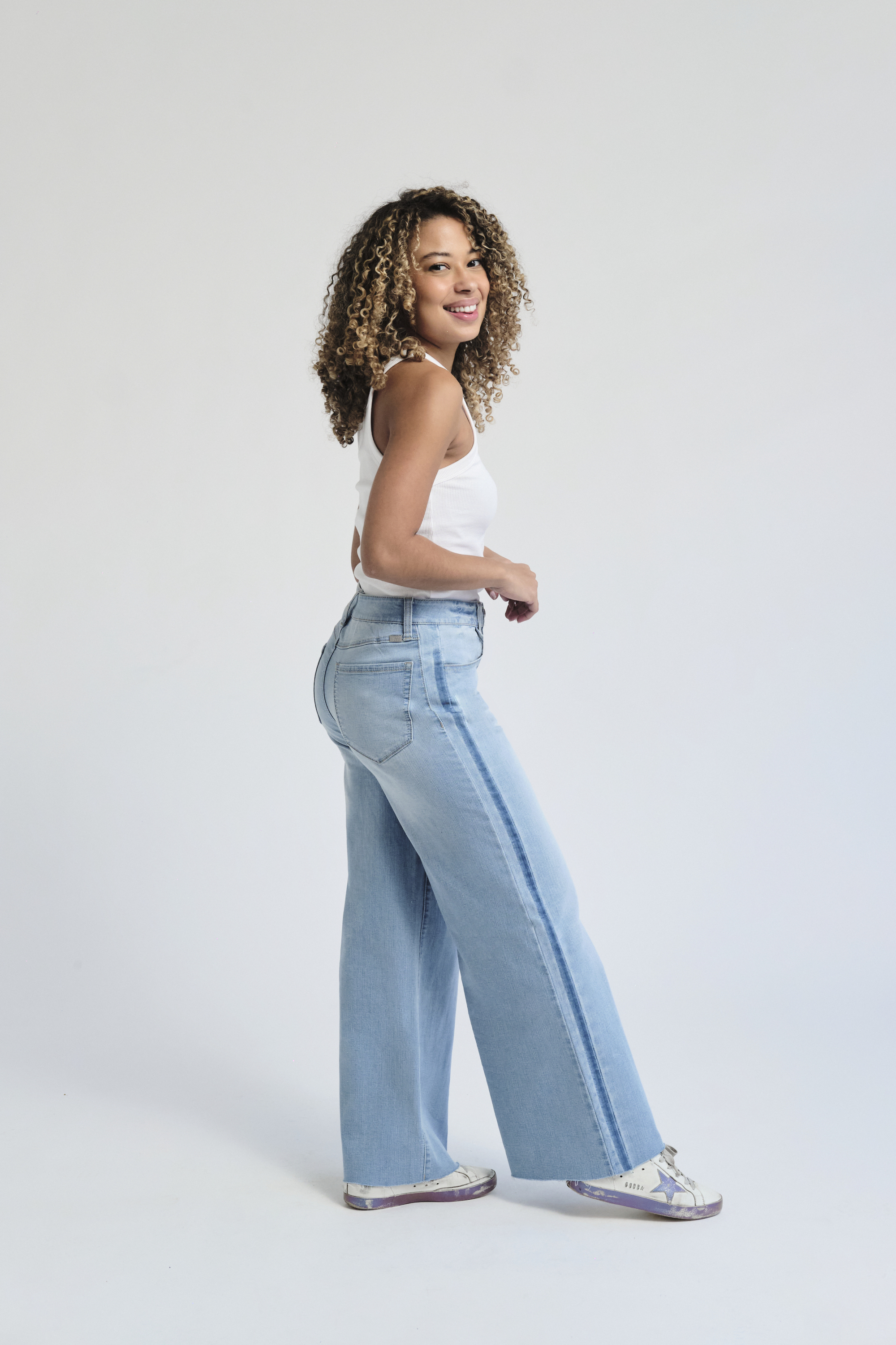 Meet our #1 best selling spring style of 2025! It features a contrasting tuxedo stripe down the side (shadow masking) in two-tone denim and a raw hem perfect for anyone!! 
