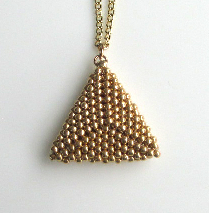 Hundreds of tiny seed beads intricately woven into a delicate, yet impactful, pendant.