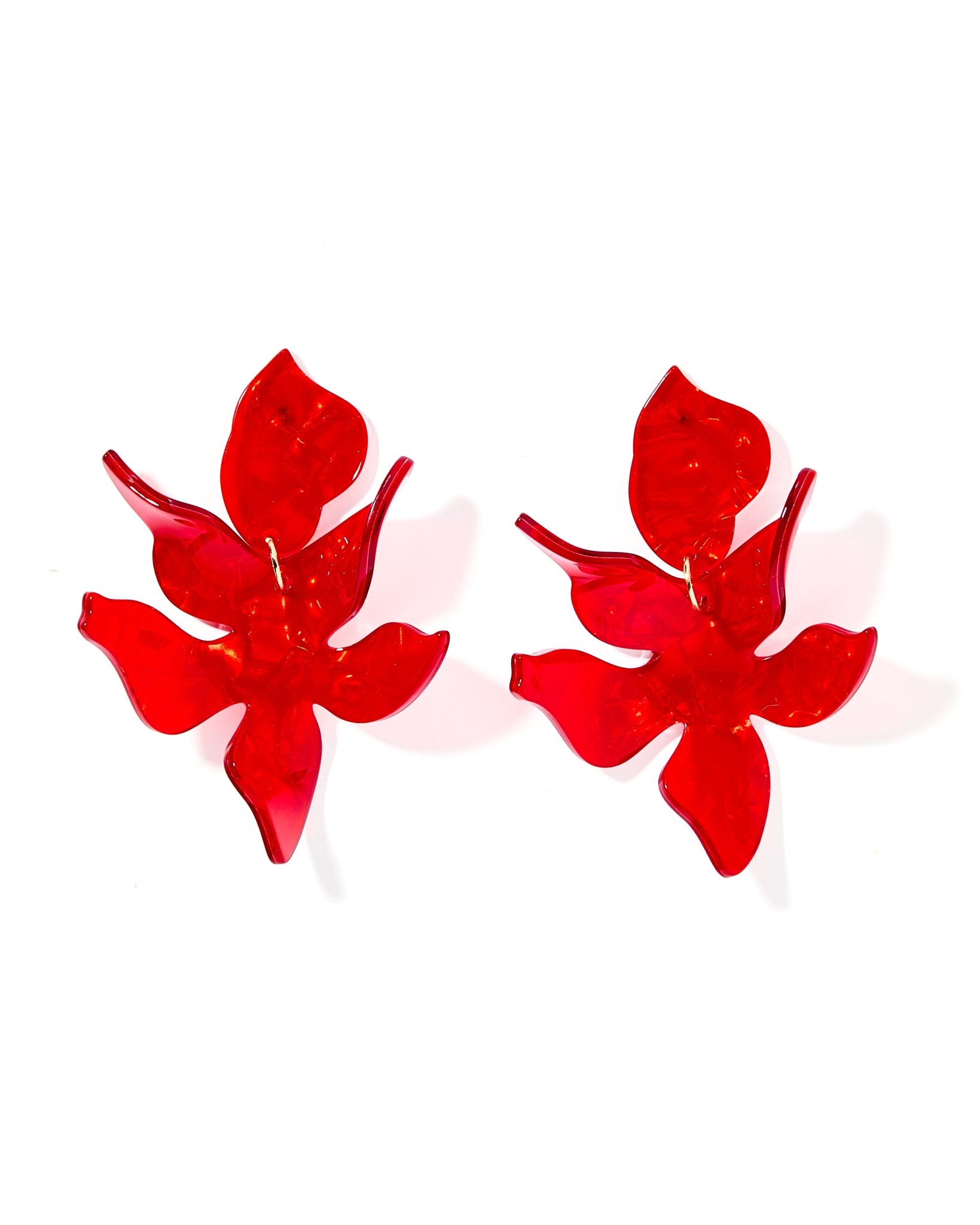 Flora Statement Earrings in Pearlized Red feature a bold oversized design with a luminous finish. Lightweight, hypoallergenic, and perfect for holidays, parties, or adding color to any look.