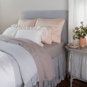 Square-quilted charmeuse shams for the transition from headboard to pillows. 