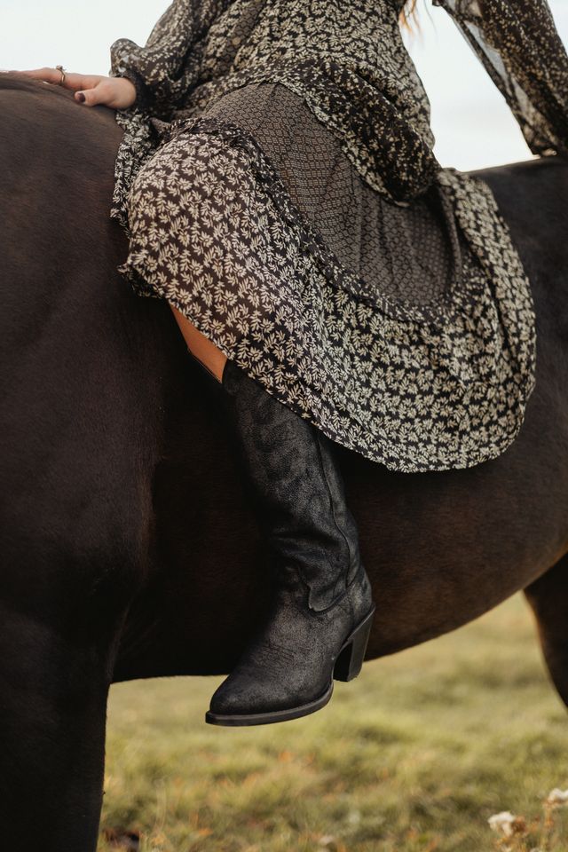 Girl on horse in cowboy boots