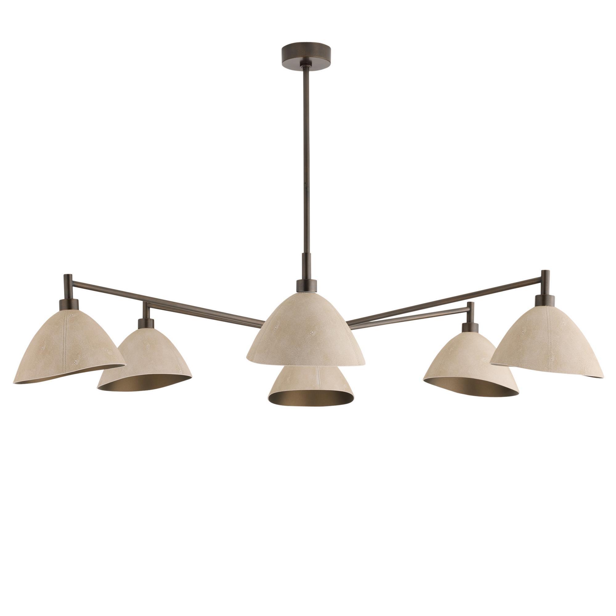 Faux shagreen leather is carefully shaped and stitched to form the shades of the Inlet. Embossed with a shagreen stingray texture, the ivory domes suspend from a linear arm of English bronze steel. 