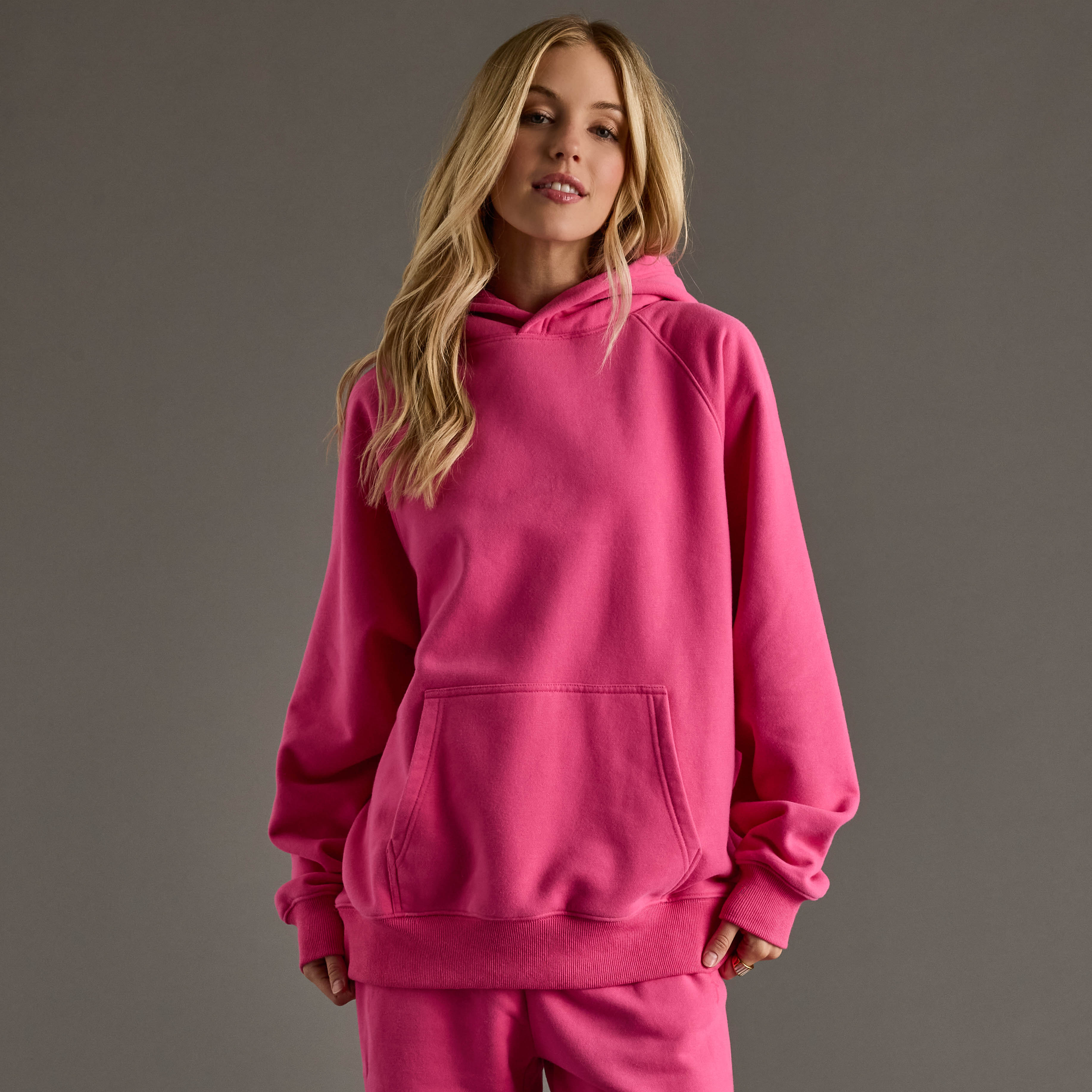 Bright Pink Panache Hooded Sweatshirt featuring a relaxed fit with a cozy fleece interior, front kangaroo pocket, and ribbed cuffs and hem for casual comfort. Pairs perfectly with the matching Bright 