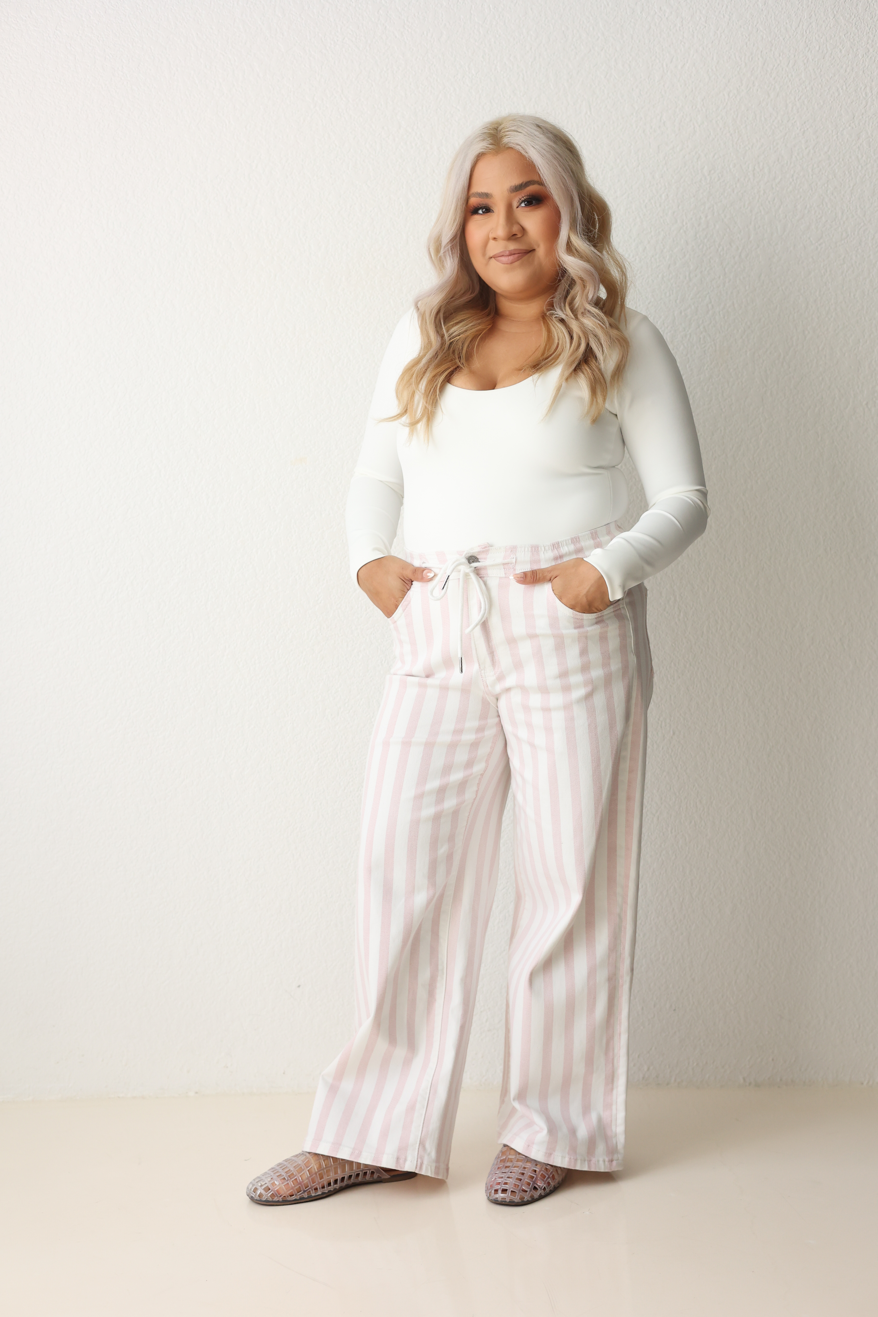 A relaxed wide-leg fit, playful pink pinstripes, and a comfortable drawstring waistband for an easy everyday look. Soft stretch cotton blend and a 26.5" inseam, they're designed to hit 