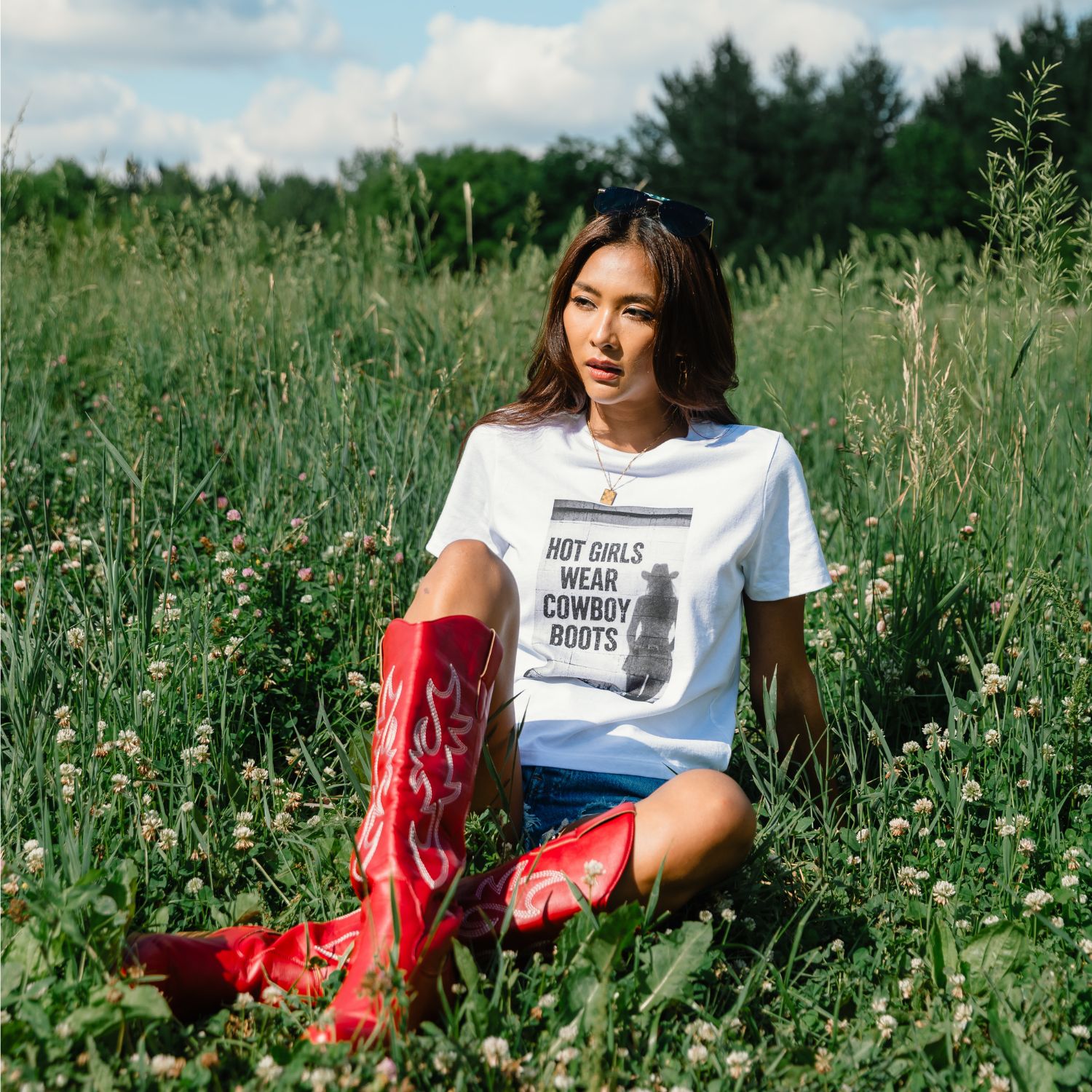White graphic tee featuring "Hot Girls Wear Cowboy Boots" design, crafted with a classic crew neckline, short sleeves, and a relaxed fit in soft breathable fabric for effortless everyday wear.