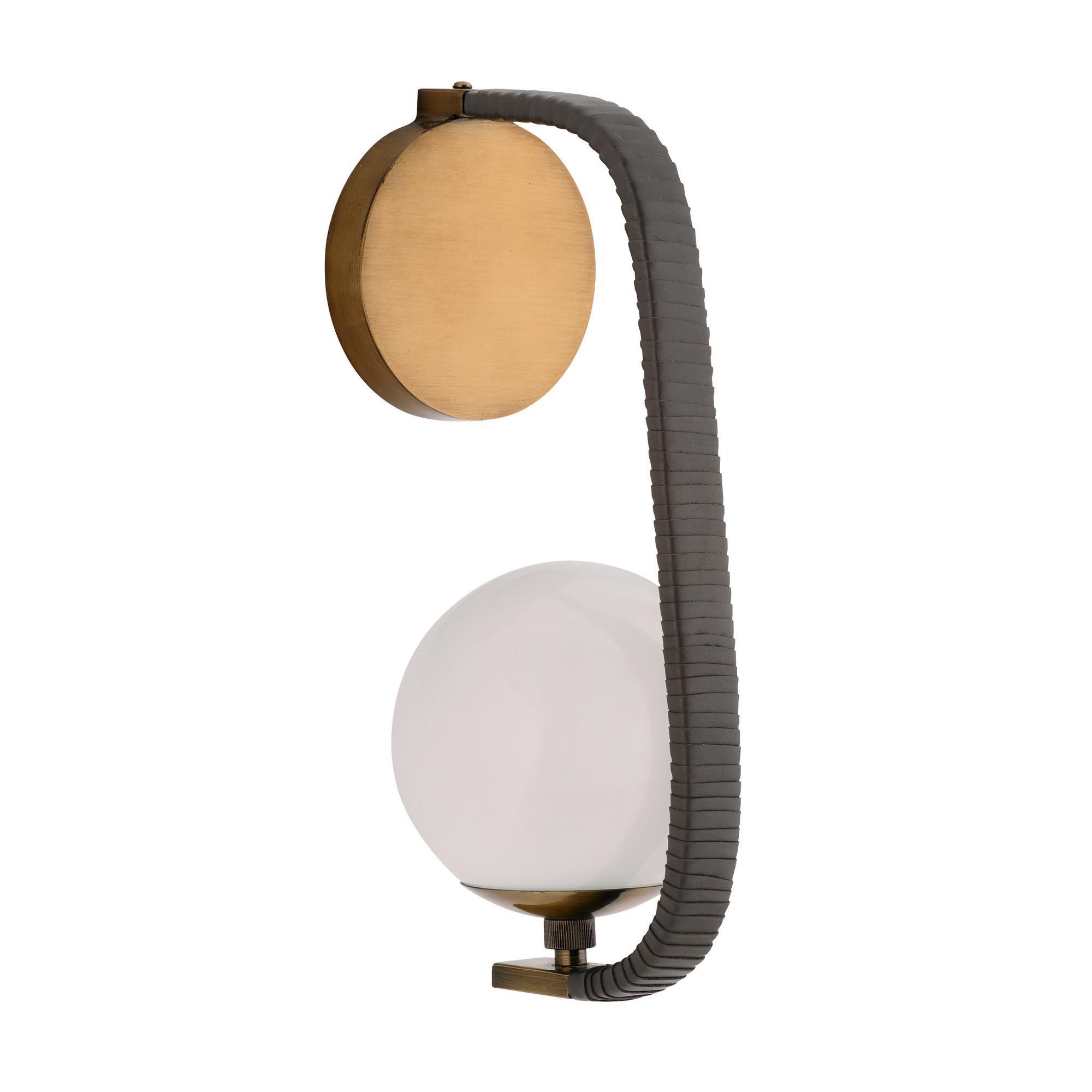 Wrapped in ore leather, this tailored and masculine style is secured to the wall with a backplate of antique brass-plated iron