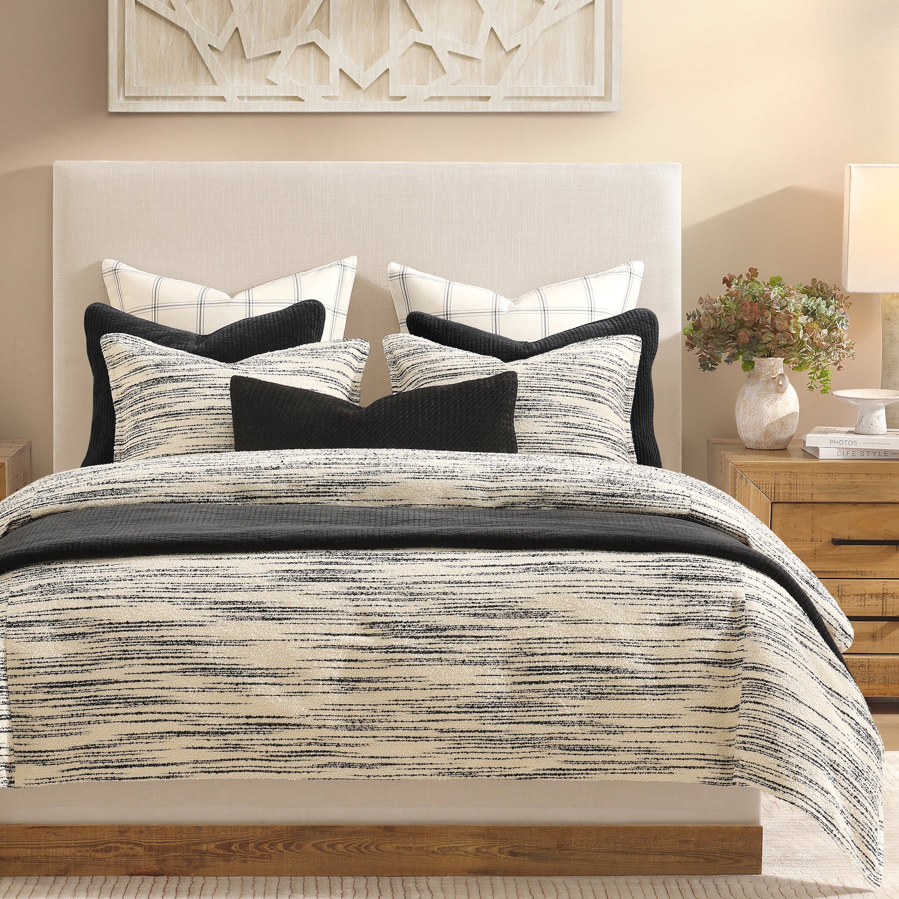 Delicate, artistic bouclé stripes in crisp ivory and deep black create a captivating visual rhythm in our Cosmo Bedding Set. Each thread meticulously space-dyed for perfect contrast.