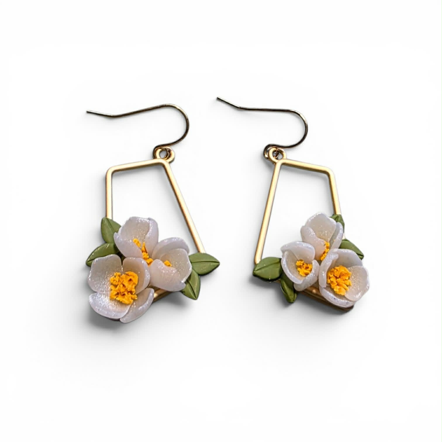 Handcrafted polymer clay earrings from the Grounded Bloom Collection, with sculpted flowers and leaves in symbolic shades of black, terracotta, and white. Lightweight, botanical, and full of meaning.