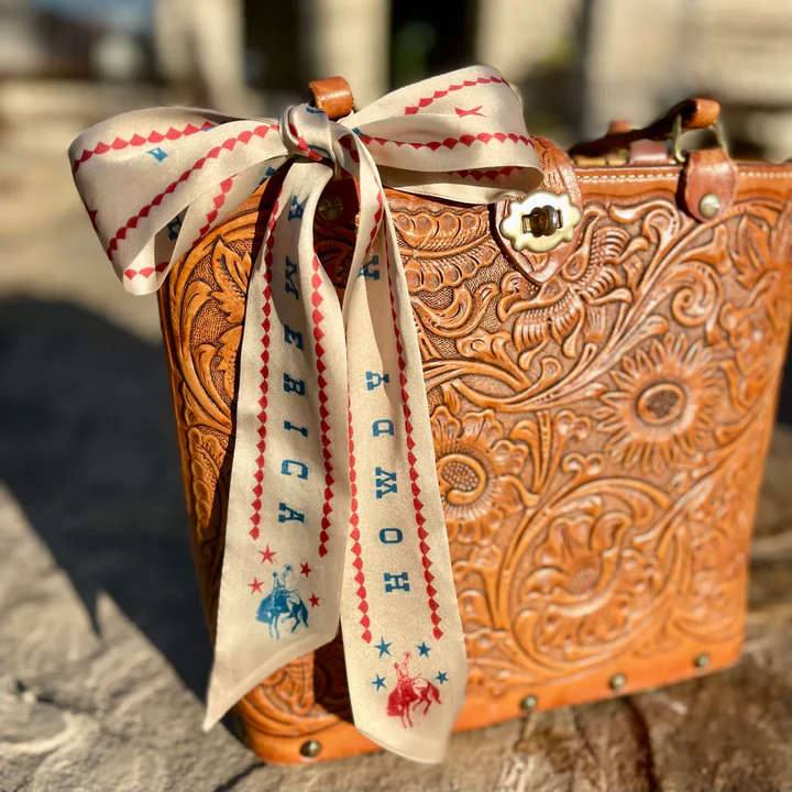 The Howdy America Twilly is red, white, and rodeo-ready. Perfect to tie on a handbag, in your hair, through your boot or around your neck!