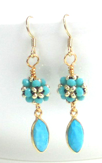 Woven crystals and a bezeled turquoise dangle earring.