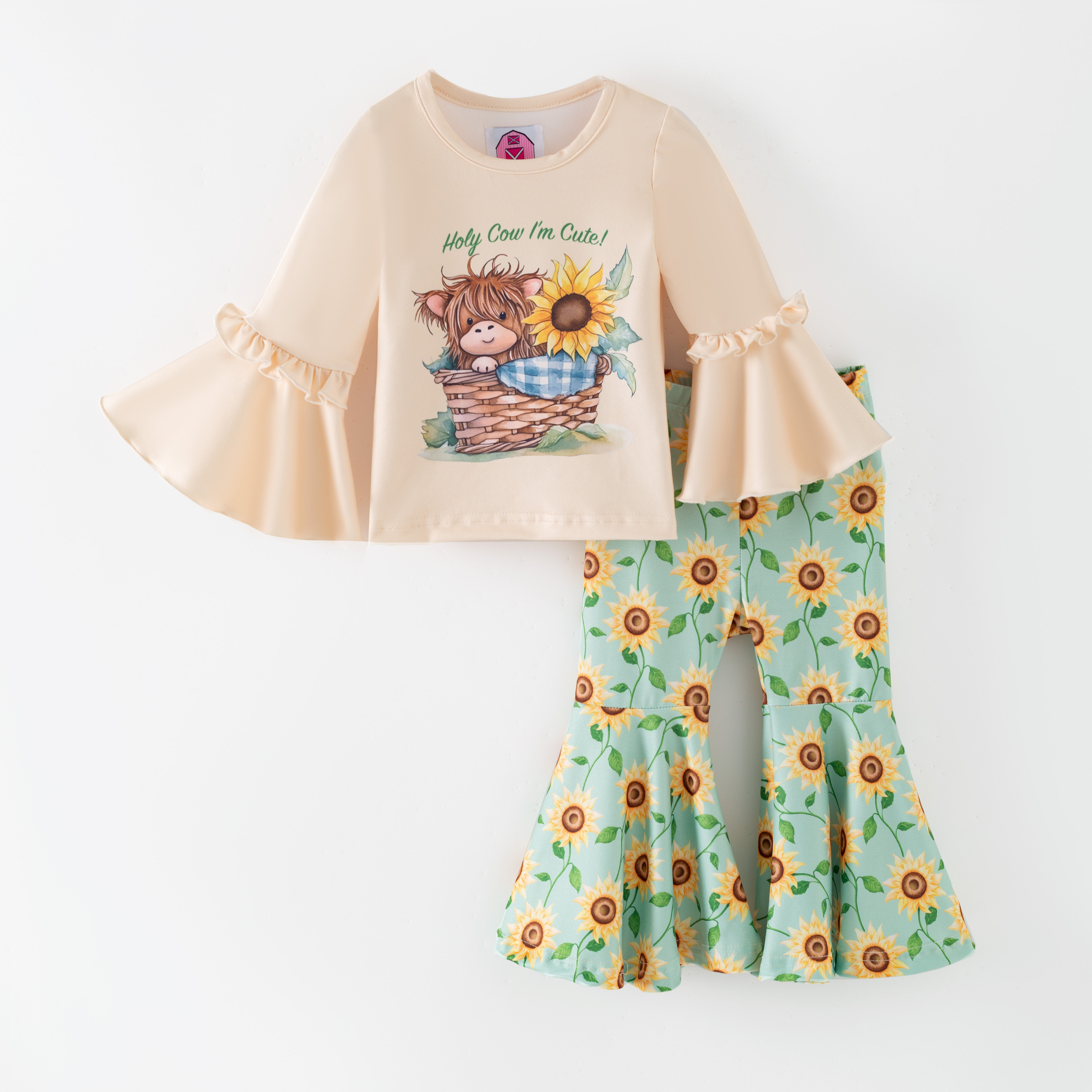 This charming two-piece set brings playful personality to her everyday wardrobe with a sweet highland cow and sunflower print. 