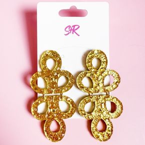 As seen in Vogue! Make a statement with these stunning gold lamé acrylic dangle earrings, as photographed and featured on Vogue.com.